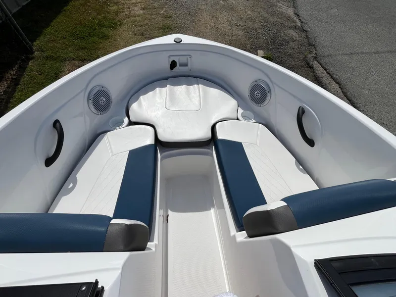Slide: The Image of 2023 Tahoe 185 S boat interior with blue and white seating, speakers, and handles. - 10