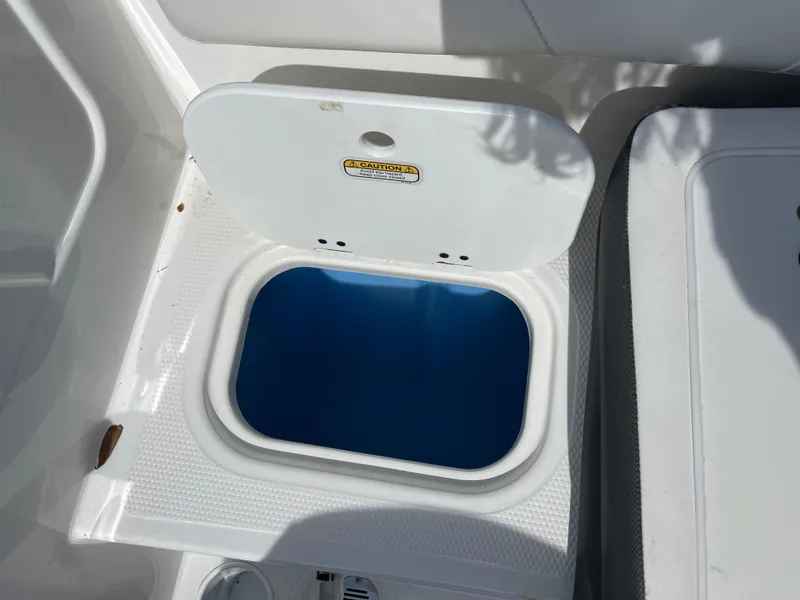 Slide: The Image of Open storage compartment on 2023 Tahoe 185 S boat, featuring a blue interior. - 14