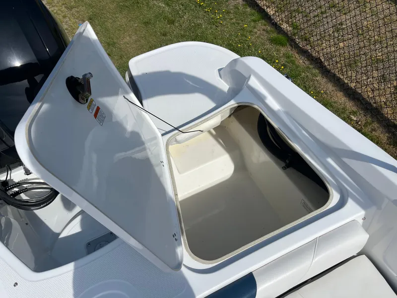 Slide: The Image of 2023 Tahoe 185 S boat storage compartment open, showcasing spacious interior design. - 16