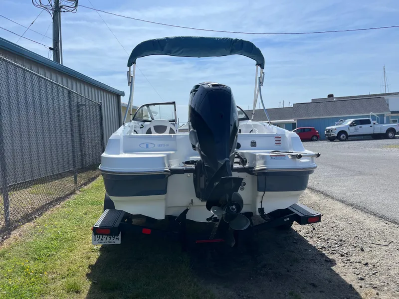 Slide: The Image of 2023 Tahoe 185 S boat with outboard motor, parked outdoors on a sunny day. - 19