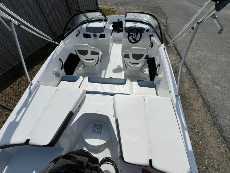 Slide: The Image of 2023 Tahoe 185 S boat interior with white seating and steering console. - 2