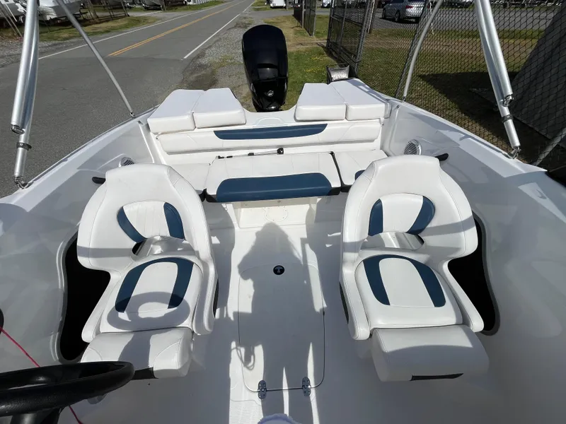 Slide: The Image of 2023 Tahoe 185 S boat interior with white seating and steering wheel. - 9