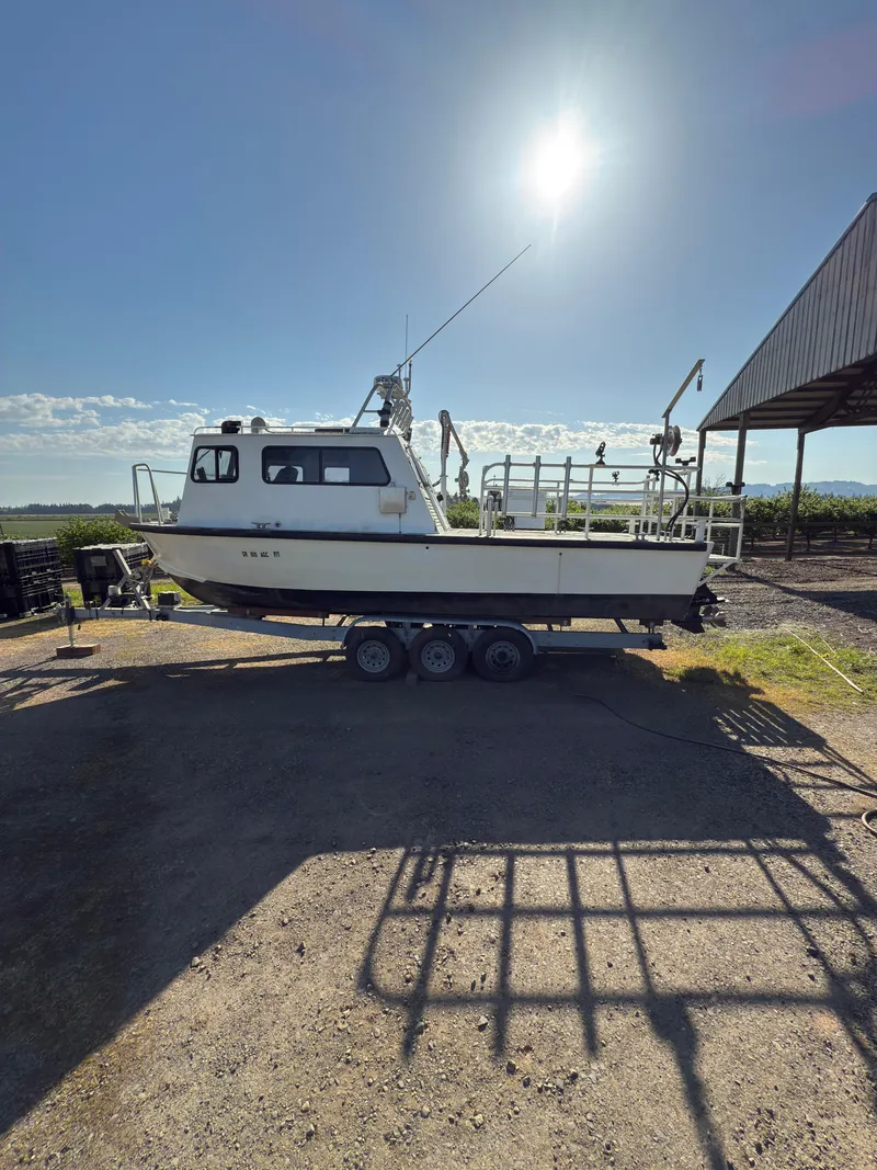 The Image of 1975 Monark 30 Fishing Boat on trailer under sunny sky. - 1
