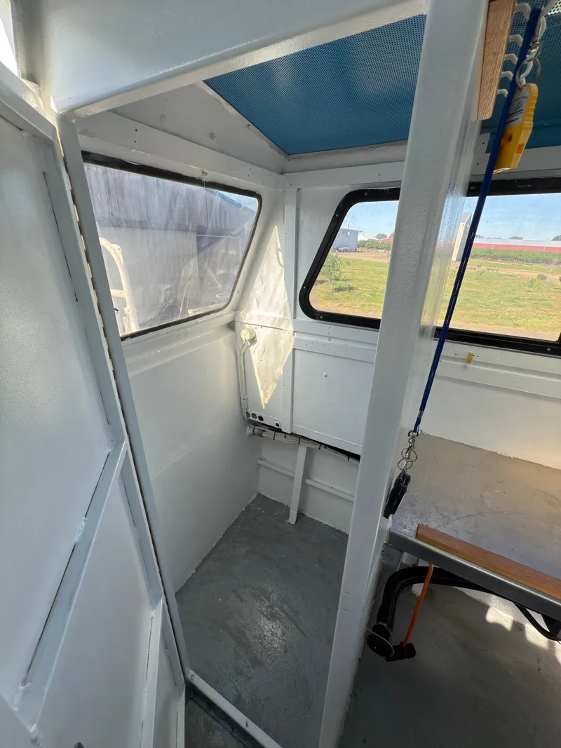 Slide: The Image of 1975 Monark 30 Fishing Boat interior with windows and seating area. - 10