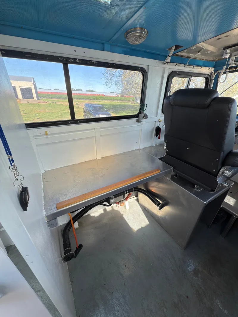 Slide: The Image of Interior of a 1975 Monark 30 Fishing Boat with seating and window view. - 11
