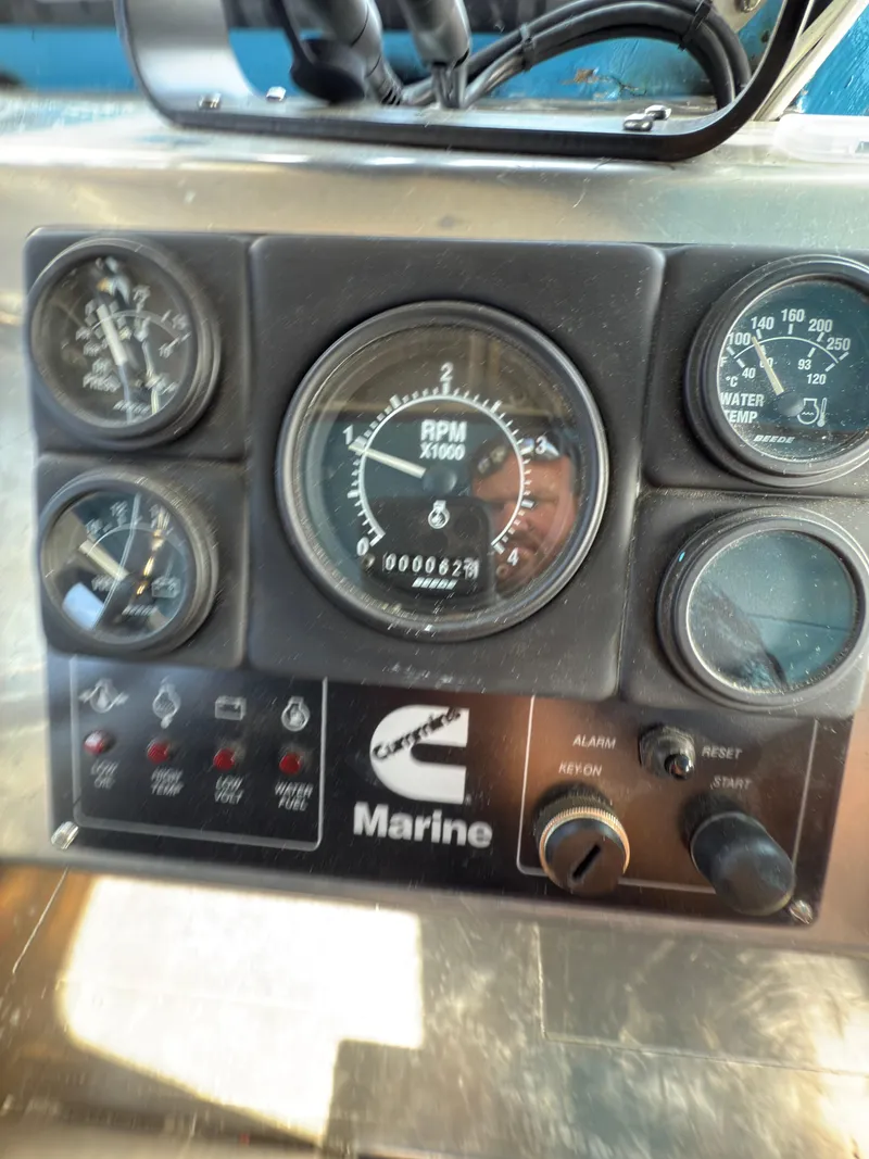 Slide: The Image of Control panel of a 1975 Monark 30 Fishing Boat with gauges and Cummins Marine branding. - 15