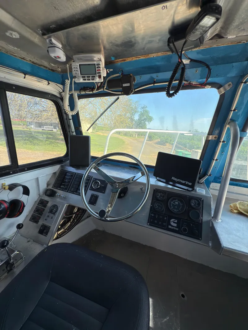 Slide: The Image of Interior of a 1975 Monark 30 Fishing Boat cockpit with steering wheel and navigation equipment. - 16