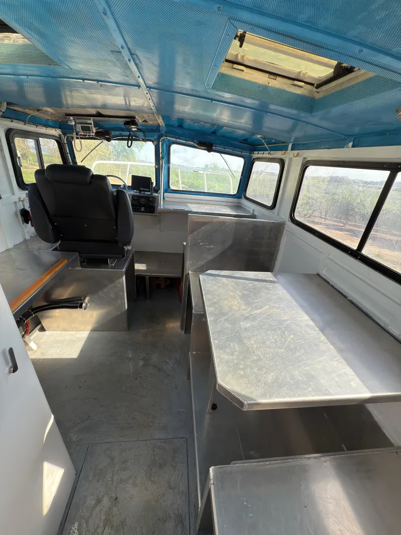 Slide: The Image of Interior of a 1975 Monark 30 Fishing Boat with blue ceiling and metal furnishings. - 19