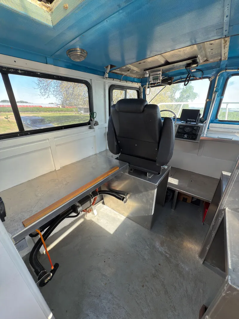 Slide: The Image of Interior of a 1975 Monark 30 Fishing Boat with seating and navigation equipment. - 20