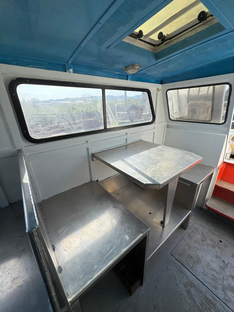 Slide: The Image of Interior of a 1975 Monark 30 Fishing Boat with metal seating and table. - 23