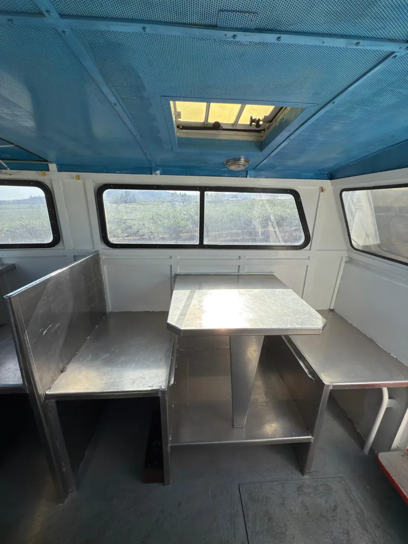 Slide: The Image of Interior of 1975 Monark 30 Fishing Boat with blue ceiling and seating area. - 24