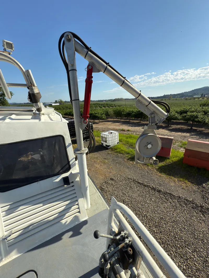 Slide: The Image of 1975 Monark 30 Fishing Boat with crane, docked outdoors under clear sky. - 6