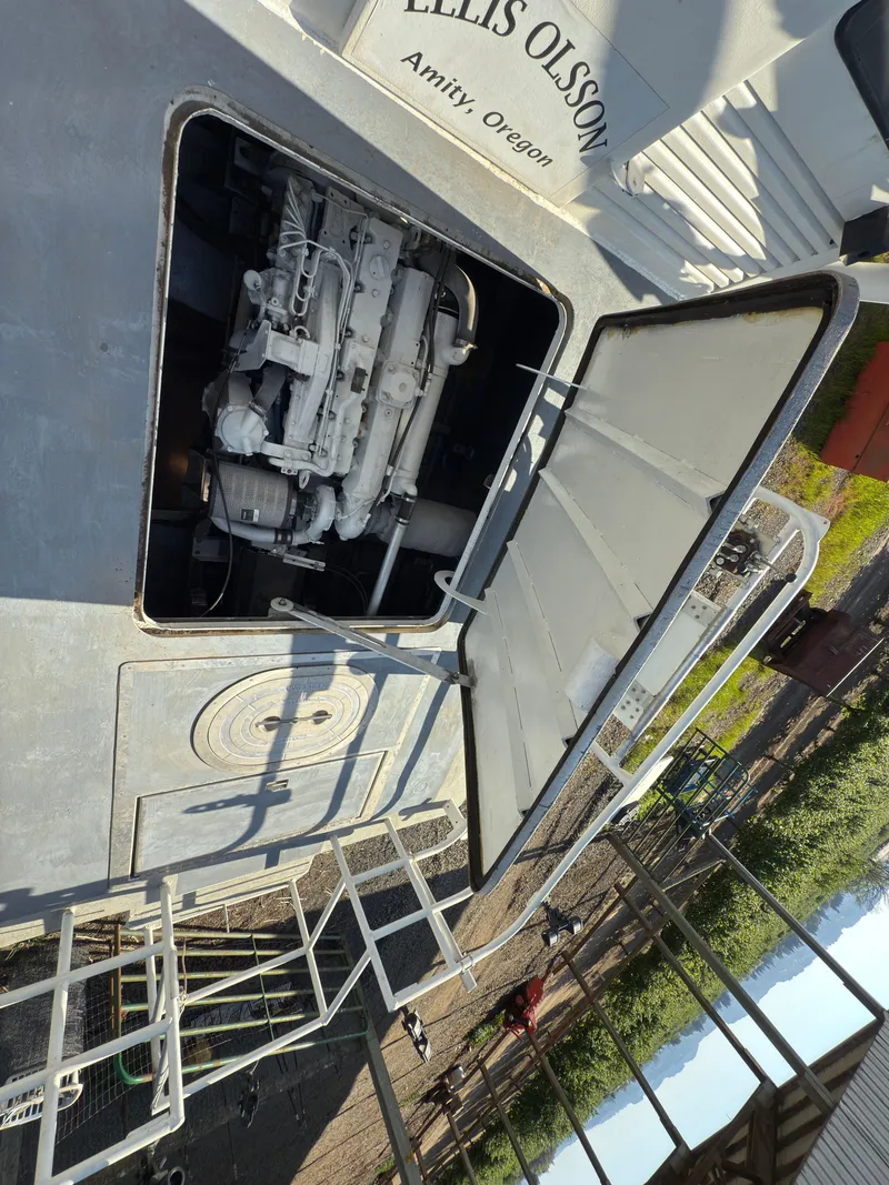 Slide: The Image of 1975 Monark 30 Fishing Boat engine compartment open, showcasing internal machinery. - 9