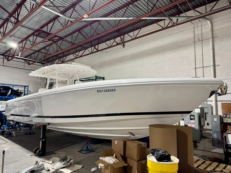 Slide: The Image of 2020 Intrepid 407 Nomad FE boat in a warehouse setting. - 0