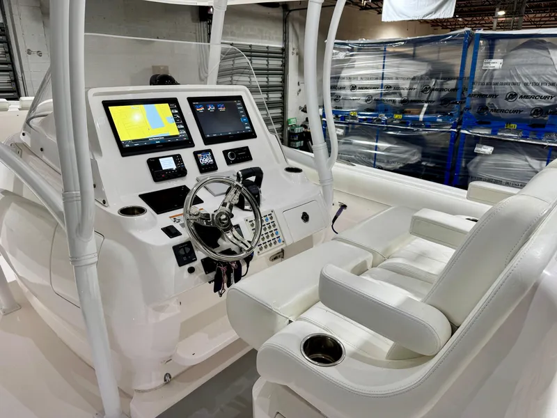Slide: The Image of 2020 Intrepid 407 Nomad FE boat cockpit with modern navigation system and white seating. - 11