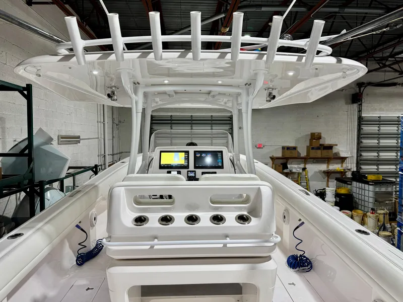 Slide: The Image of 2020 Intrepid 407 Nomad FE boat interior with advanced navigation system in a warehouse setting. - 12