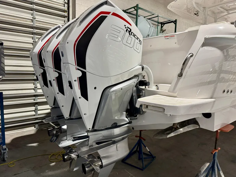 Slide: The Image of Triple outboard engines on a 2020 Intrepid 407 Nomad FE boat in a garage. - 21