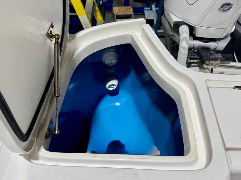 Slide: The Image of Open storage compartment on 2020 Intrepid 407 Nomad FE boat, featuring a blue interior. - 26