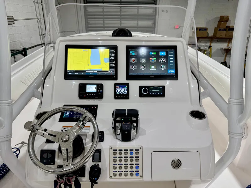 Slide: The Image of 2020 Intrepid 407 Nomad FE boat dashboard with navigation screens and controls. - 3