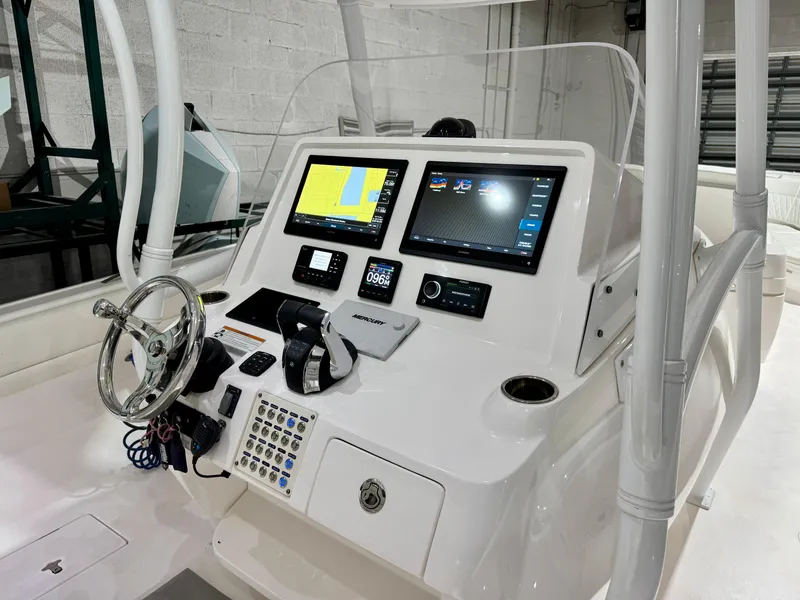 Slide: The Image of 2020 Intrepid 407 Nomad FE boat console with dual navigation screens and steering wheel. - 4