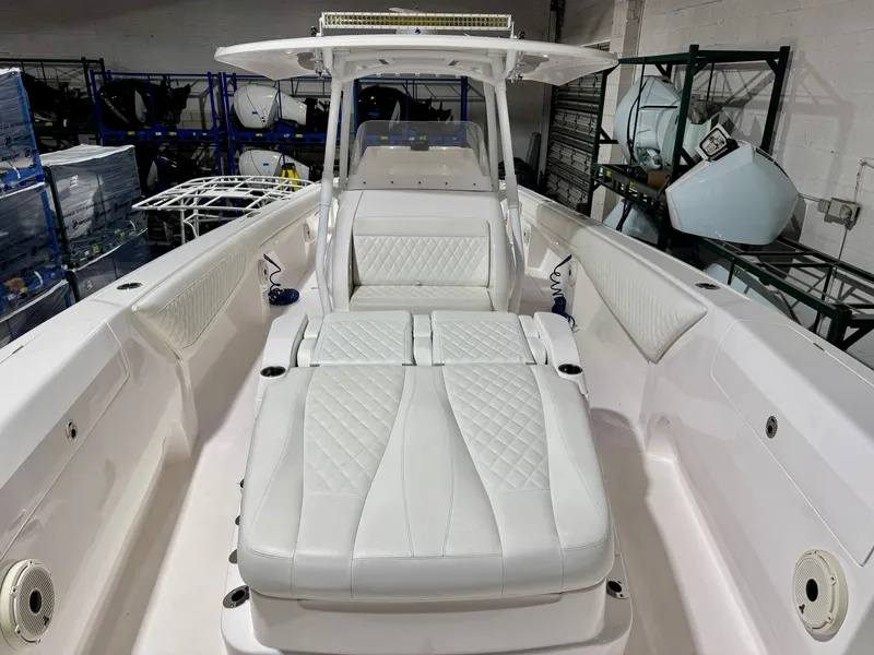 Slide: The Image of 2020 Intrepid 407 Nomad FE boat interior with white cushioned seating and sleek design. - 5