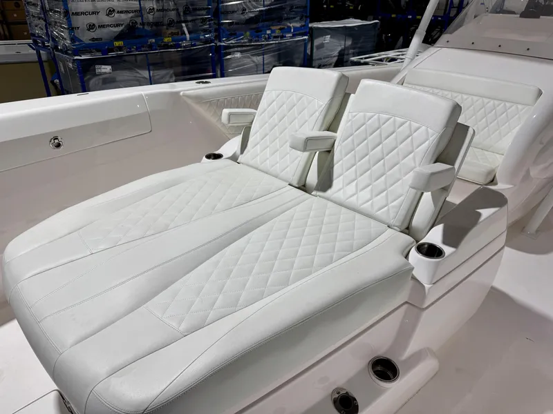 Slide: The Image of Luxurious white seating on 2020 Intrepid 407 Nomad FE boat, featuring quilted design and cup holders. - 6