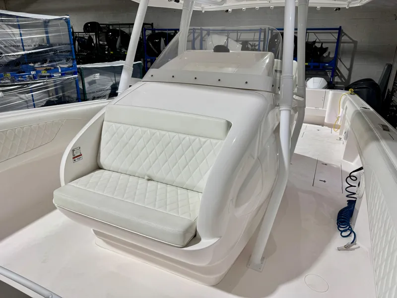 Slide: The Image of 2020 Intrepid 407 Nomad FE boat interior with white seating and console. - 8