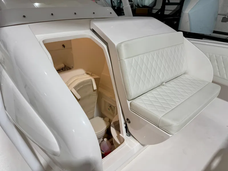 Slide: The Image of 2020 Intrepid 407 Nomad FE boat interior with white seating and storage compartment. - 9