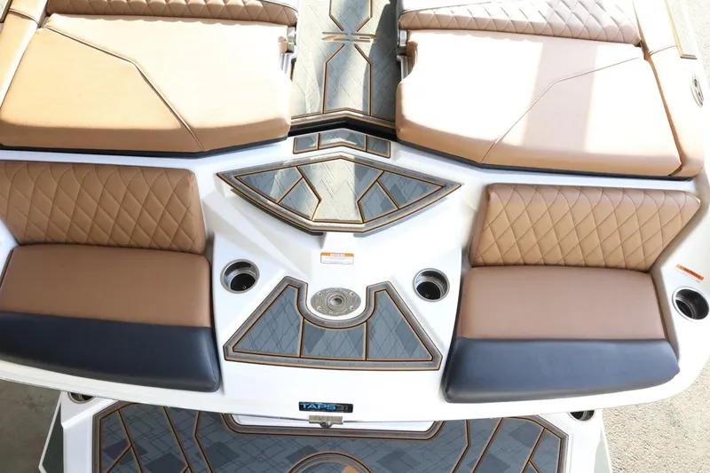 Slide: The Image of 2025 Tigé Z3 boat interior with brown quilted seats and sleek design. - 11