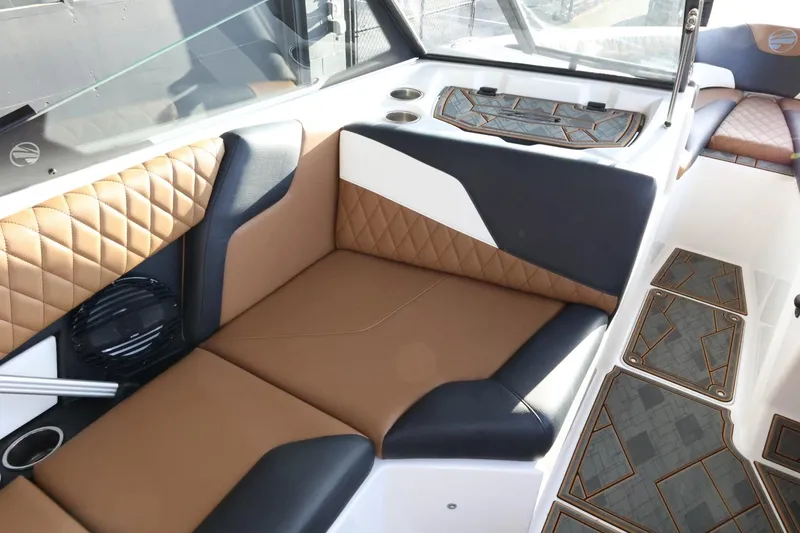 Slide: The Image of 2025 Tigé Z3 boat interior with brown and black leather seating, quilted design, and modern flooring. - 15