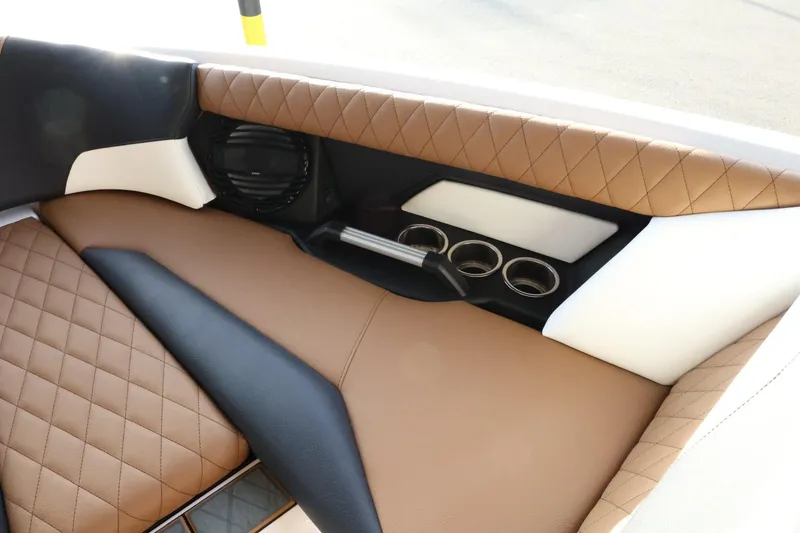 Slide: The Image of 2025 Tigé Z3 boat interior with brown quilted seats and cup holders. - 19