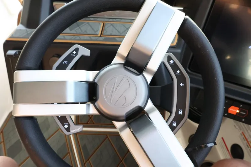 Slide: The Image of Steering wheel of 2025 Tigé Z3 boat with modern controls and sleek design. - 23