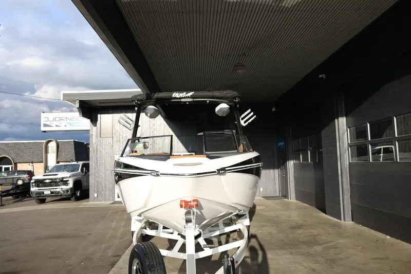 Slide: The Image of 2025 Tigé Z3 boat on trailer outside a modern building. - 3