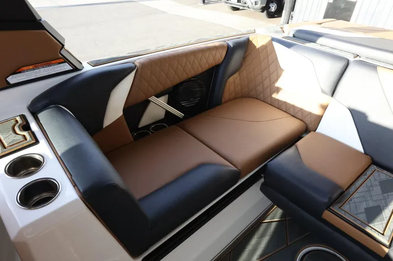 Slide: The Image of 2025 Tigé Z3 boat interior with luxurious brown and black seating, cup holders, and stylish design. - 31