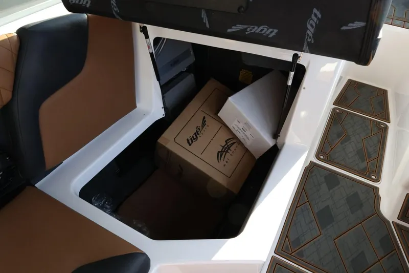 Slide: The Image of Storage compartment in 2025 Tigé Z3 boat with boxes and seating. - 32