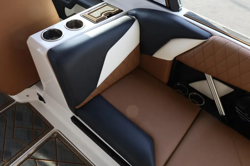 Slide: The Image of 2025 Tigé Z3 boat interior with brown and black leather seats, cup holders, and stylish design. - 33