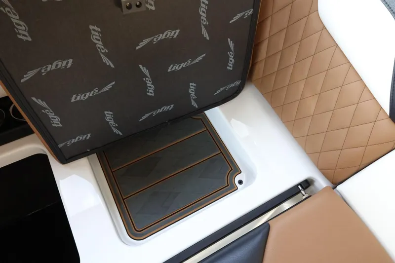 Slide: The Image of 2025 Tigé Z3 boat interior with quilted leather seating and storage compartment. - 35