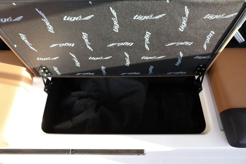 Slide: The Image of 2025 Tigé Z3 boat storage compartment with branded interior lining. - 36