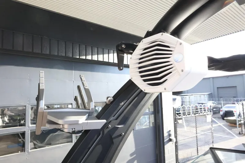 Slide: The Image of 2025 Tigé Z3 boat with mounted speaker and board rack, docked in a marina. - 37