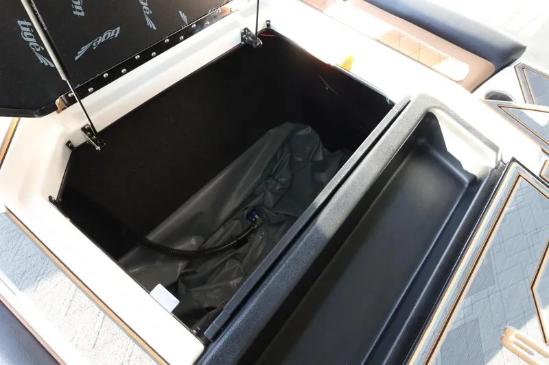 Slide: The Image of 2025 Tigé Z3 boat storage compartment with open lid and interior view. - 38