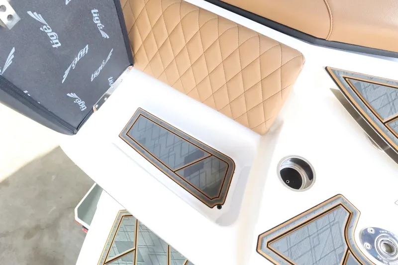 Slide: The Image of 2025 Tigé Z3 boat interior with tan quilted seats and sleek design accents. - 46