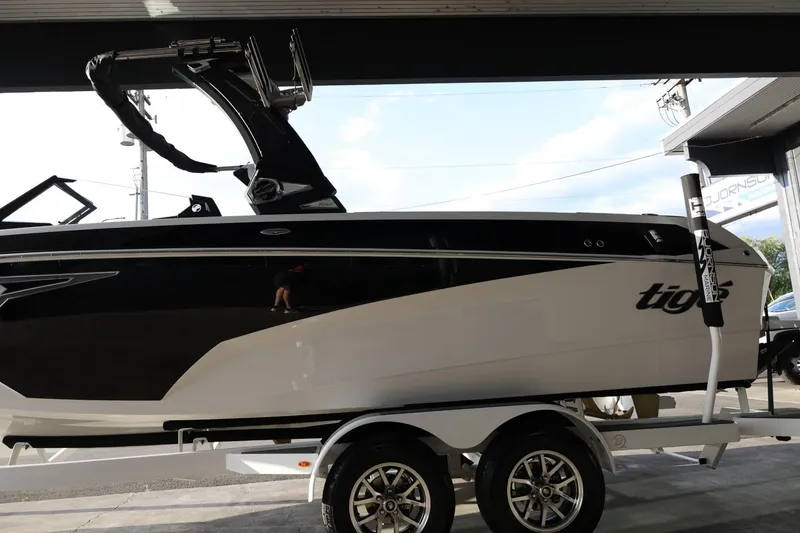 Slide: The Image of 2025 Tigé Z3 boat on trailer, black and white design, parked in a garage. - 5
