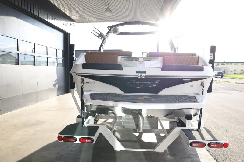 Slide: The Image of 2025 Tigé Z3 boat rear view in a sunlit garage setting. - 7