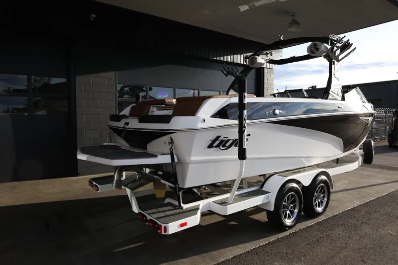 Slide: The Image of 2025 Tigé Z3 boat on trailer, parked outdoors, showcasing sleek design and modern features. - 9