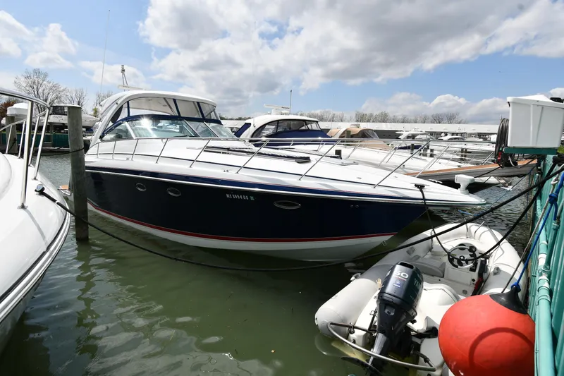Slide: The Image of 2009 Formula 40 PC yacht docked in marina, surrounded by other boats under cloudy sky. - 1