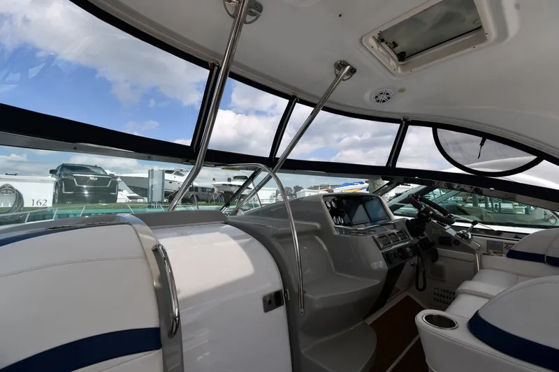 Slide: The Image of Interior view of a 2009 Formula 40 PC yacht, featuring modern controls and seating. - 11