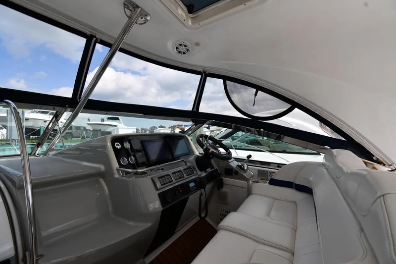 Slide: The Image of 2009 Formula 40 PC yacht cockpit with modern controls and white seating. - 12
