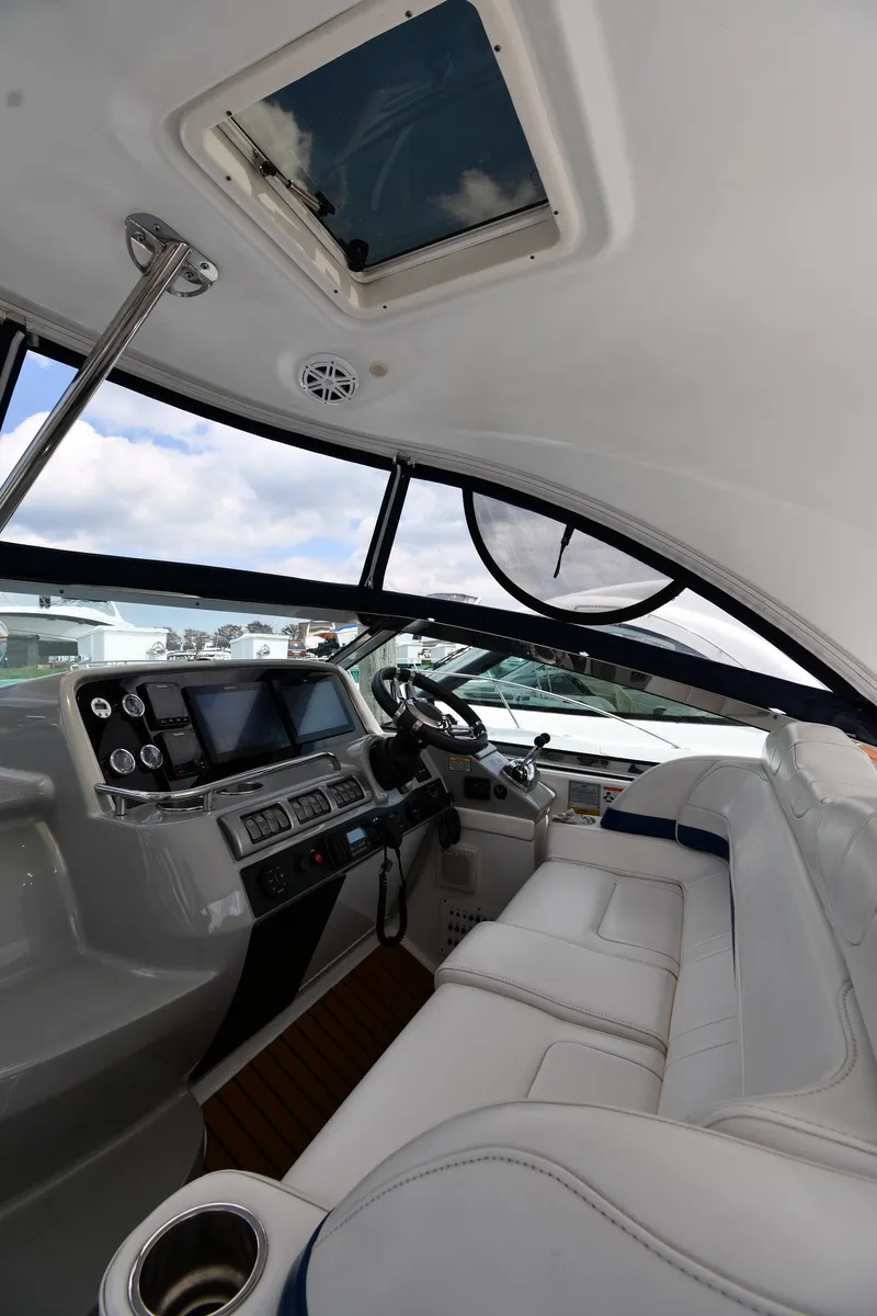 Slide: The Image of 2009 Formula 40 PC yacht cockpit with modern controls and plush seating. - 13