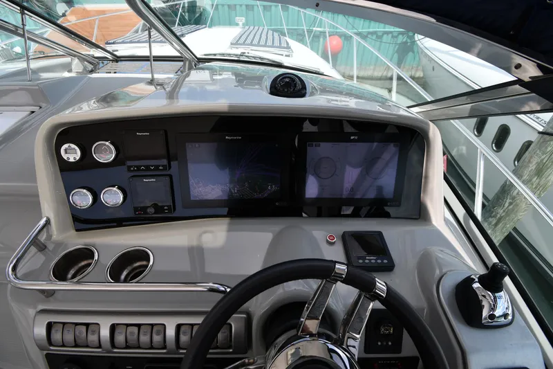 Slide: The Image of 2009 Formula 40 PC yacht dashboard with navigation screens and controls. - 14