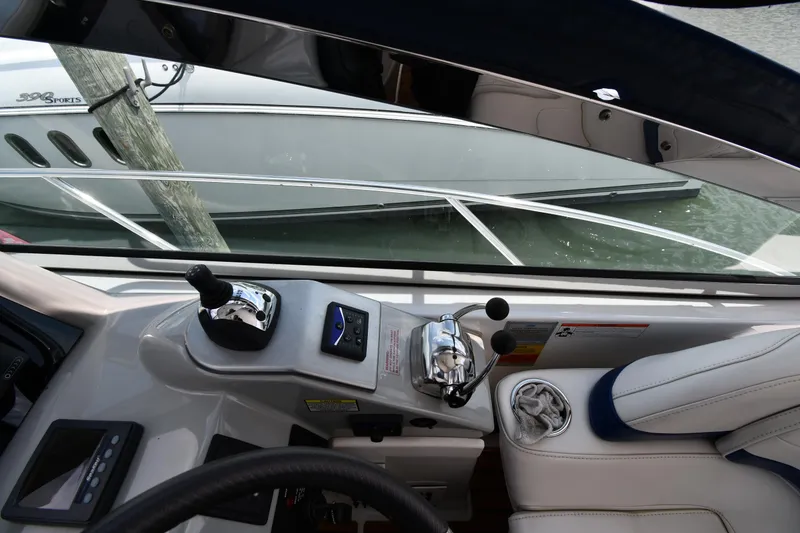 Slide: The Image of Cockpit view of a 2009 Formula 40 PC boat with control levers and seating. - 16